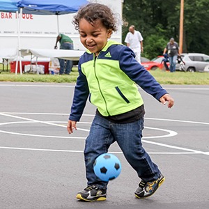 Young boy happy and playing soccer
